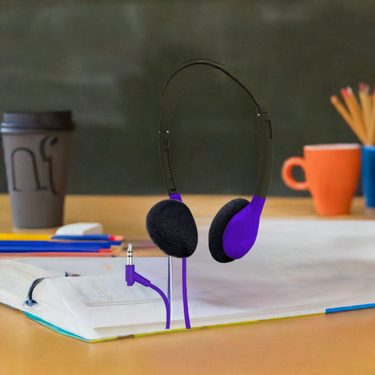 HamiltonBuhl purple on-ear school headphones on a desk with stationery, perfect bulk school headphone choice for learning.